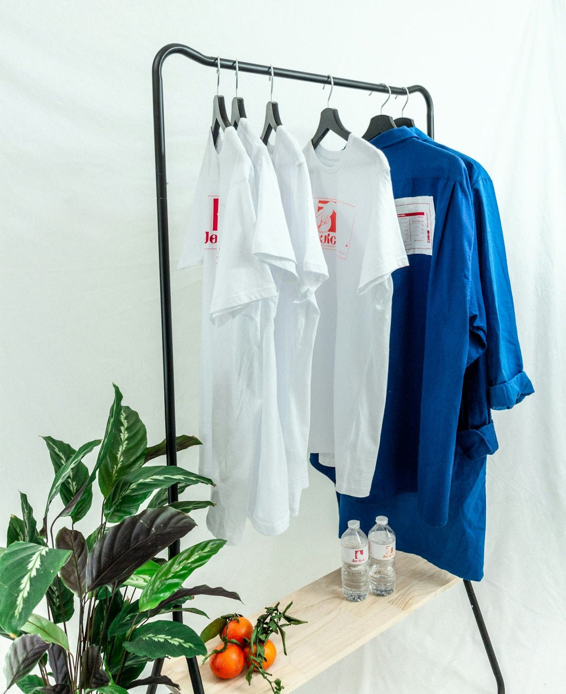 white button up shirt hanging on black metal rack