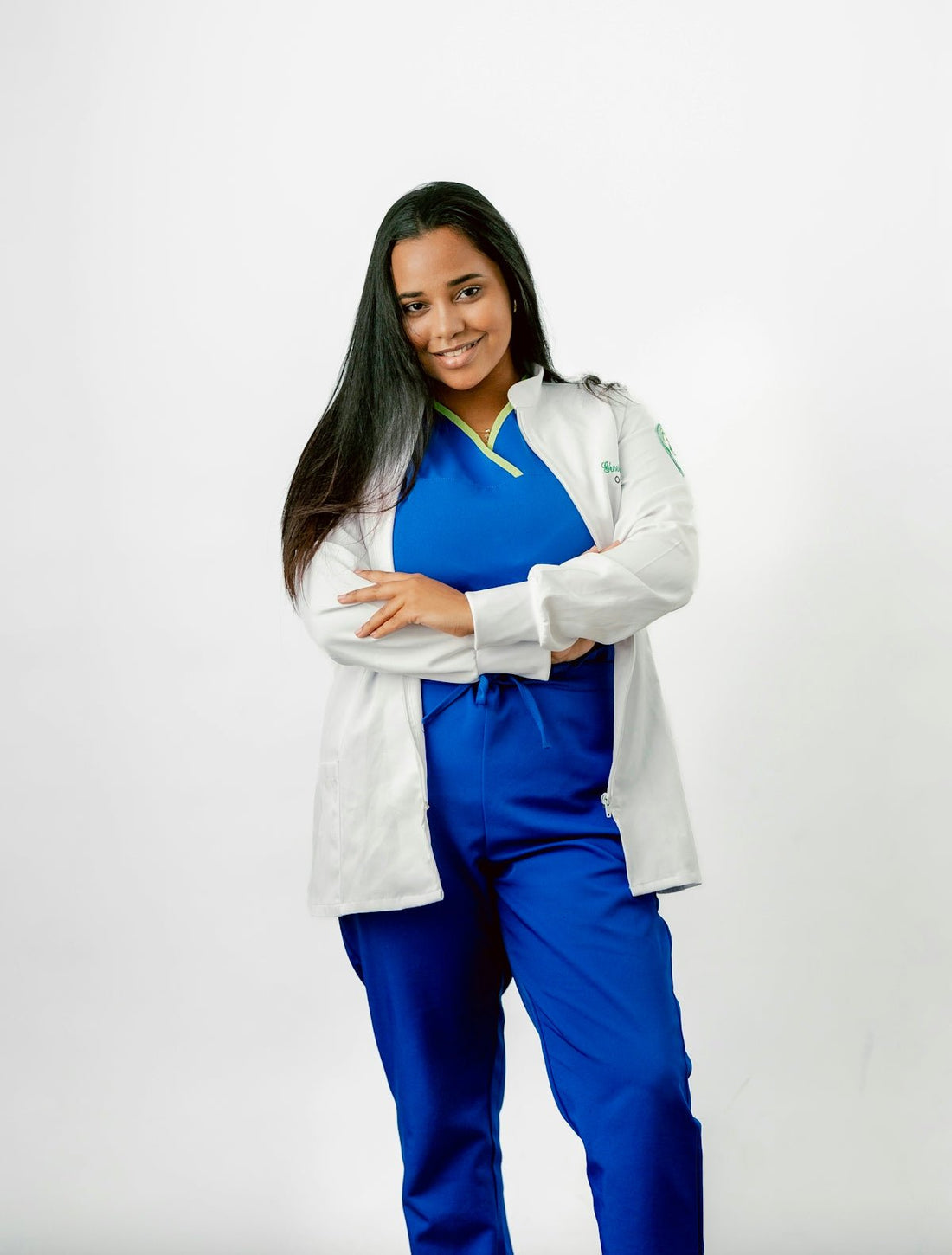 A woman in scrubs posing for a picture