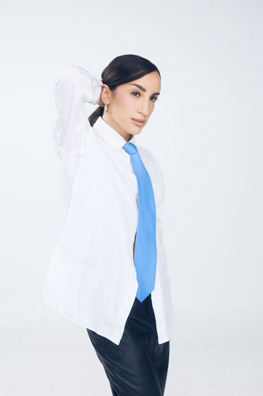 Woman in white shirt and blue tie