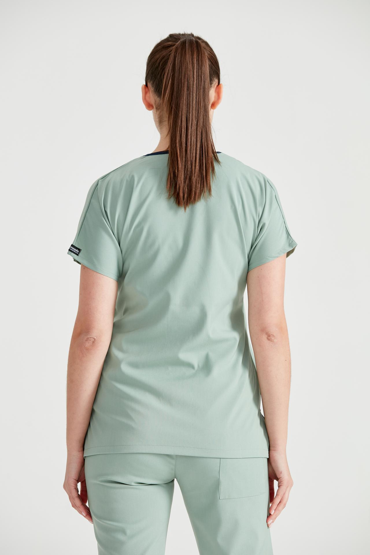 Asistenta medicala imbracata in costum medical de dama din elastan, verde fistic, vedere din spate